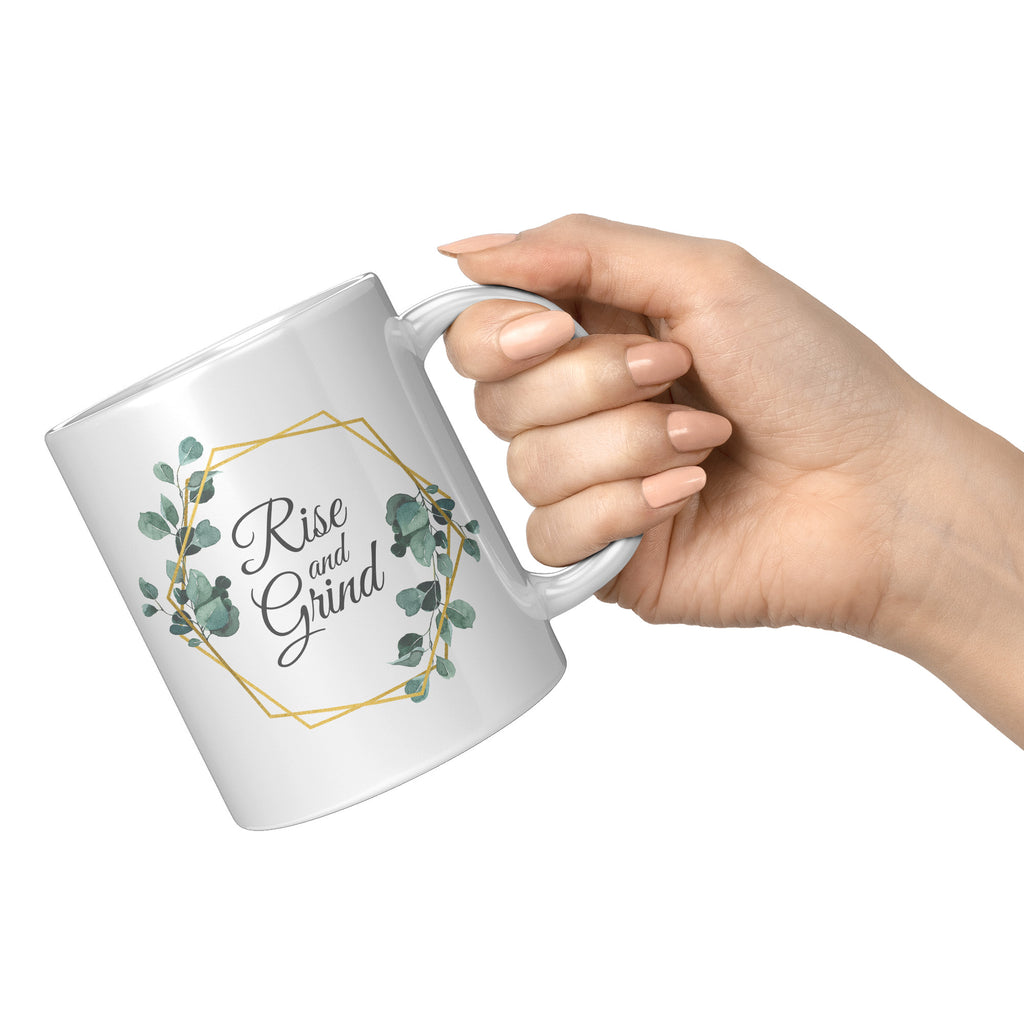 https://www.mugafriend.com/cdn/shop/files/Rise_and_Grind_Mug_11oz_White_RH_Model_Mockup_png_1024x1024.jpg?v=1686718383